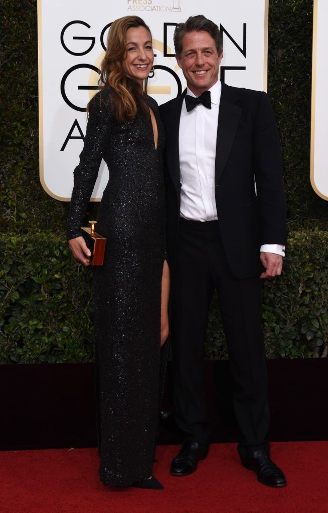 Hugh Grant (R) and  Anna Elisabet Eberstein arrive at the 74th annual Golden Globe Awards, January 8, 2017, at the Beverly Hilton Hotel in Beverly Hills, California.       (Photo VALERIE MACON/AFP/Getty Images)