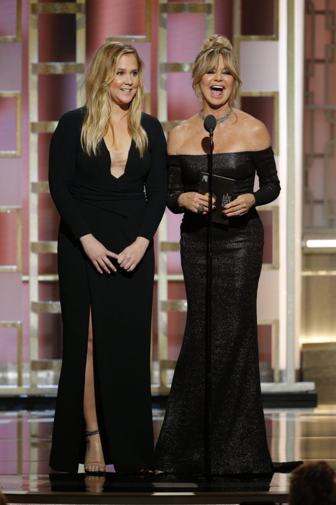 BEVERLY HILLS, CA - JANUARY 08: In this handout photo provided by NBCUniversal, presenters Amy Schumer (L) and Goldie Hawn onstage during the 74th Annual Golden Globe Awards at The Beverly Hilton Hotel on January 8, 2017 in Beverly Hills, California. (Photo by Paul Drinkwater/NBCUniversal via Getty Images)