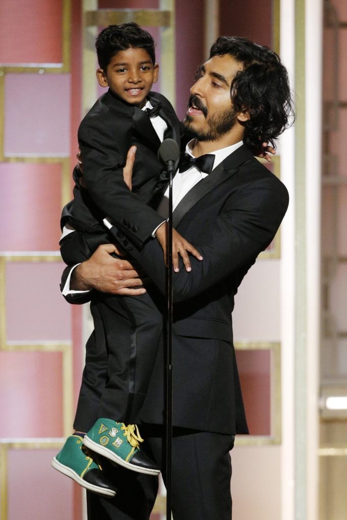 BEVERLY HILLS, CA - JANUARY 08: In this handout photo provided by NBCUniversal, presenters Sunny Pawar (L) and Dev Patel onstage during the 74th Annual Golden Globe Awards at The Beverly Hilton Hotel on January 8, 2017 in Beverly Hills, California. (Photo by Paul Drinkwater/NBCUniversal via Getty Images)