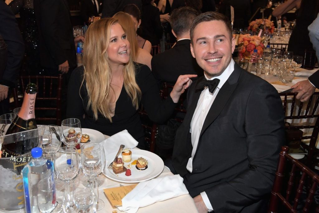 BEVERLY HILLS, CA - JANUARY 08: Actress Amy Schumer (L) and Ben Hanisch at the 74th annual Golden Globe Awards sponsored by FIJI Water at The Beverly Hilton Hotel on January 8, 2017 in Beverly Hills, California.  (Photo by Charley Gallay/Getty Images for FIJI Water)