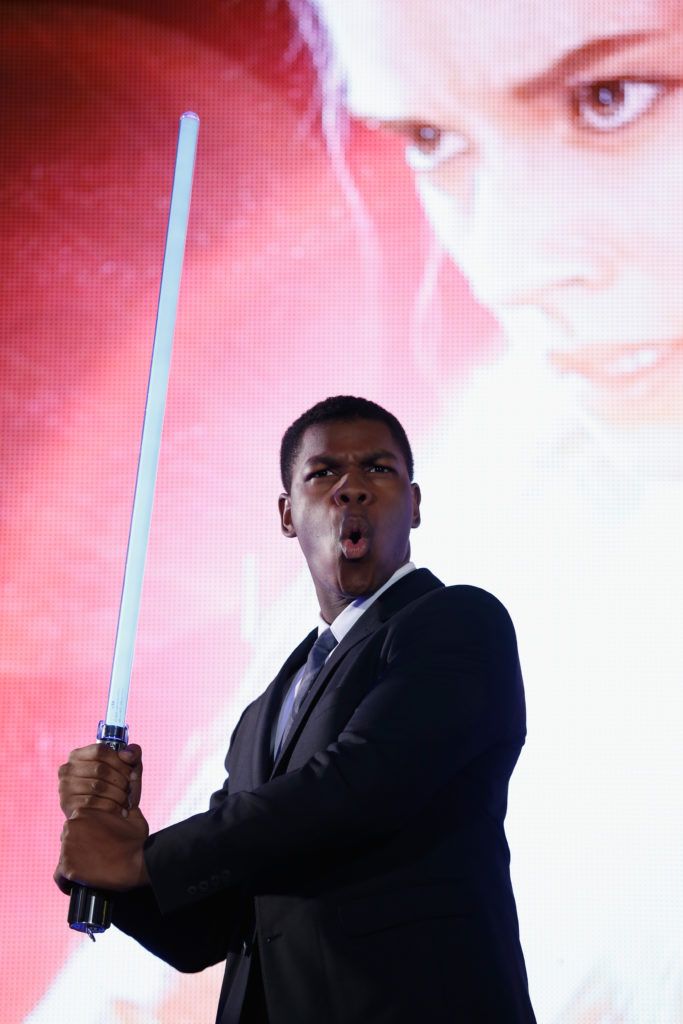 John Boyega poses with a lightsaber at the 'Star Wars: The Force Awakens' fan event at the Roppongi Hills on December 10, 2015 in Tokyo, Japan.  (Photo by Christopher Jue/Getty Images for Walt Disney Studios)