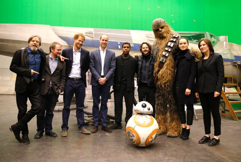 (L-R) US actor Mark Hamill, US director Rian Johnson, Britain's Prince Harry, Britain's Prince William, Duke of Cambridge, British actor John Boyega, Chewbacca and British actress Daisy Ridley pose during a tour of the Star Wars sets at Pinewood studios in Iver Heath, west of London on April 19, 2016. (Photo ADRIAN DENNIS/AFP/Getty Images)