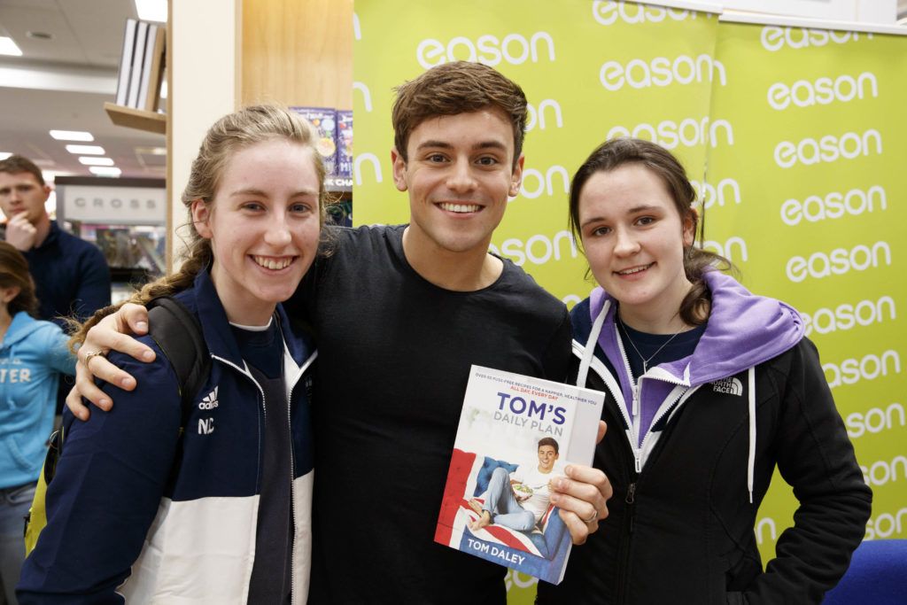 British Diving Olympian, Tom Daley, pictured with Niamh Cotter (20) and Leah Flannagan (20) from Dublin in Eason Dundrum Town Centre where he was signing copies of his new book, Tom’s Daily Plan. Picture Andres Poveda