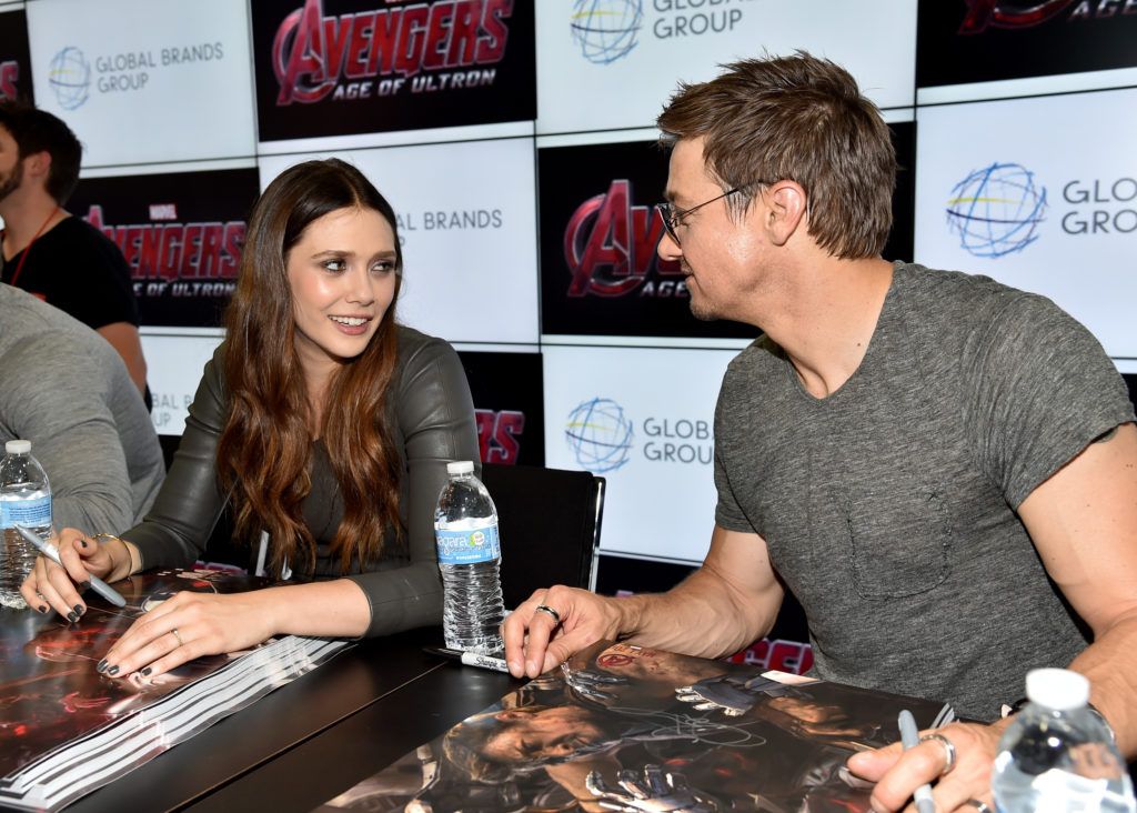 Elizabeth Olsen (L) and Jeremy Renner attend Marvel's "Avengers: Age Of Ultron" Hall H Panel Booth Signing during Comic-Con International 2014 at San Diego Convention Center on July 26, 2014 in San Diego, California.  (Photo by Alberto E. Rodriguez/Getty Images for Disney)