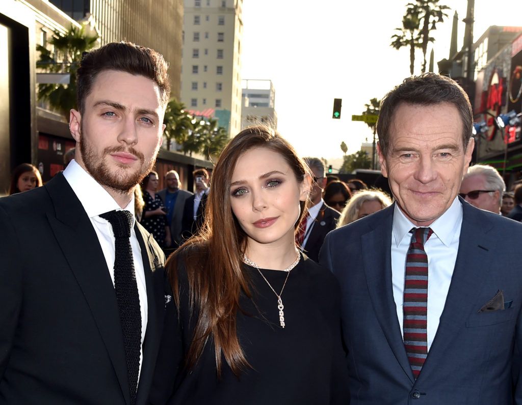 Aaron Taylor-Johnson, Elizabeth Olsen and Bryan Cranston attend the premiere of Warner Bros. Pictures and Legendary Pictures' "Godzilla" at Dolby Theatre on May 8, 2014 in Hollywood, California.  (Photo by Kevin Winter/Getty Images)