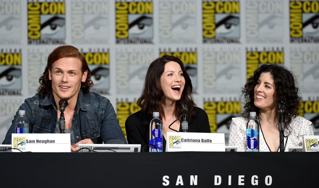 Sam Heughan, Caitriona Balfe and producer Maril Davis attend the Starz: "Outlander" panel during Comic-Con International 2015 at the San Diego Convention Center on July 11, 2015 in San Diego, California.  (Photo by Ethan Miller/Getty Images)