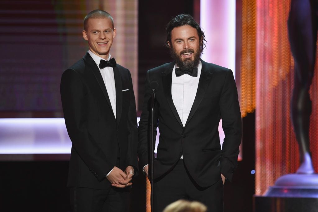 LOS ANGELES, CA - JANUARY 29:  Actor Lucas Hedges (L) and actor/director Casey Affleck speak onstage during The 23rd Annual Screen Actors Guild Awards at The Shrine Auditorium on January 29, 2017 in Los Angeles, California. 26592_014  (Photo by Kevin Winter/Getty Images )