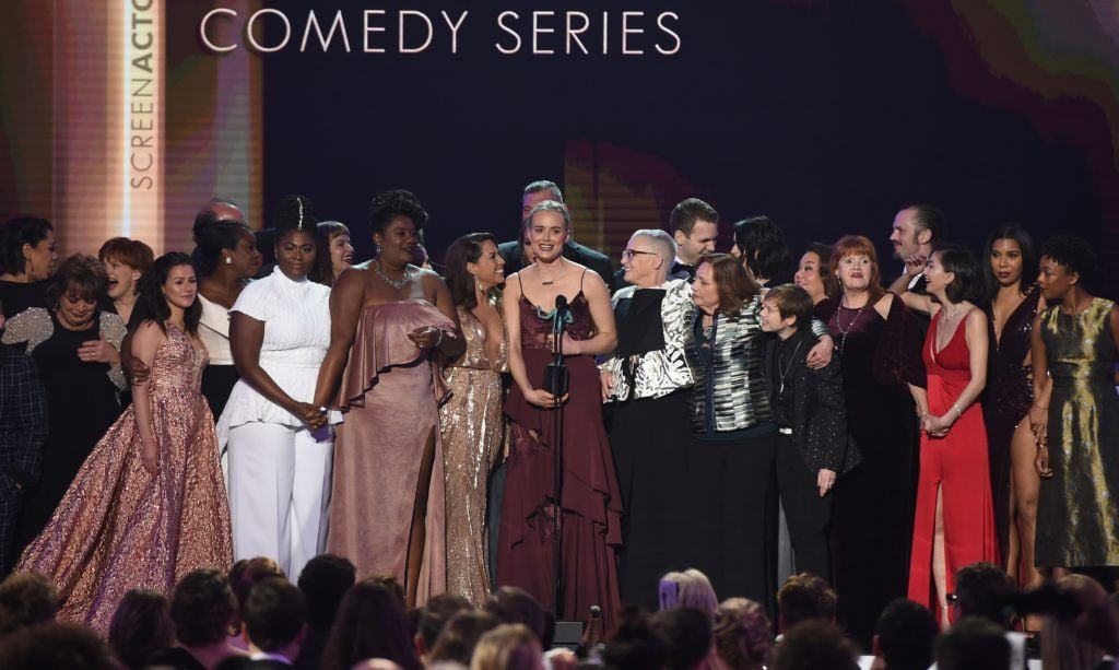 Actress Taylor Schilling (C) and the cast of 'Orange Is the New Black' accept the award for Outstanding Performance by an Ensemble in a Comedy Series onstage during the 23rd Annual Screen Actors Guild Awards show at The Shrine Auditorium on January 29, 2017 in Los Angeles, California. (Photo ROBYN BECK/AFP/Getty Images)