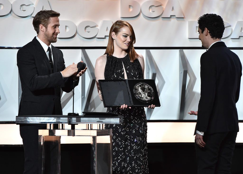 Ryan Gosling and Emma Stone present the Feature Film Nomination Plaque for La La Land to director Damien Chazelle onstage during the 69th Annual Directors Guild of America Awards at The Beverly Hilton Hotel on February 4, 2017 in Beverly Hills, California.  (Photo by Alberto E. Rodriguez/Getty Images for DGA)