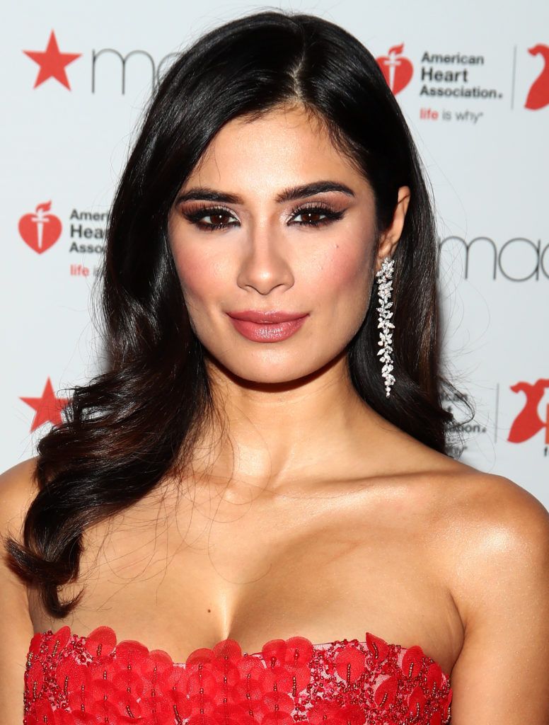 Diane Guerrero prepares backstage at the American Heart Association's Go Red For Women Red Dress Collection 2017 presented by Macy's at Fashion Week in New York City at Hammerstein Ballroom on February 9, 2017 in New York City.  (Photo by Astrid Stawiarz/Getty Images for AHA)