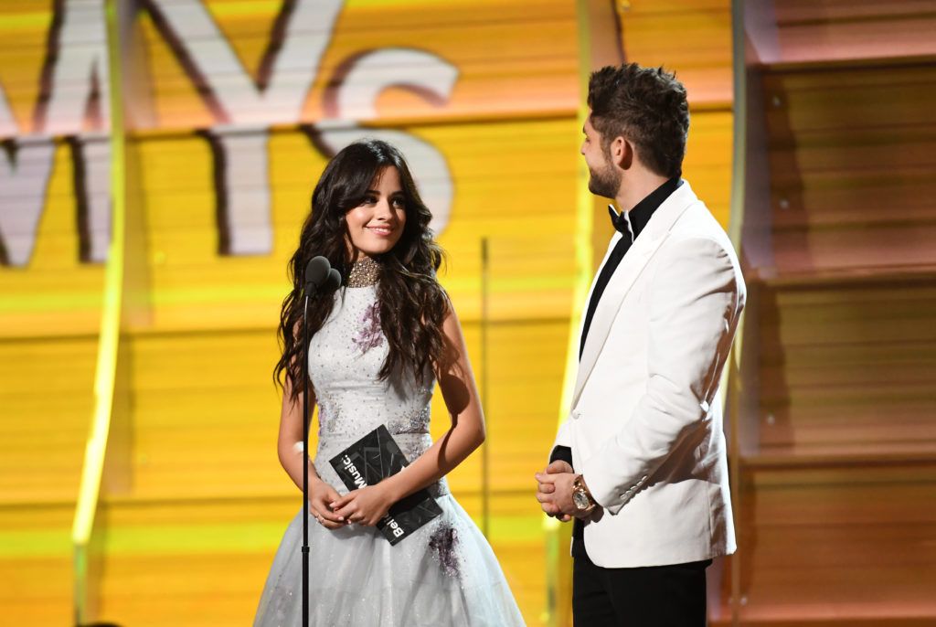 LOS ANGELES, CA - FEBRUARY 12:  Recording artists Camila Cabello (L) and Thomas Rhett speak onstage during The 59th GRAMMY Awards at STAPLES Center on February 12, 2017 in Los Angeles, California.  (Photo by Kevork Djansezian/Getty Images)