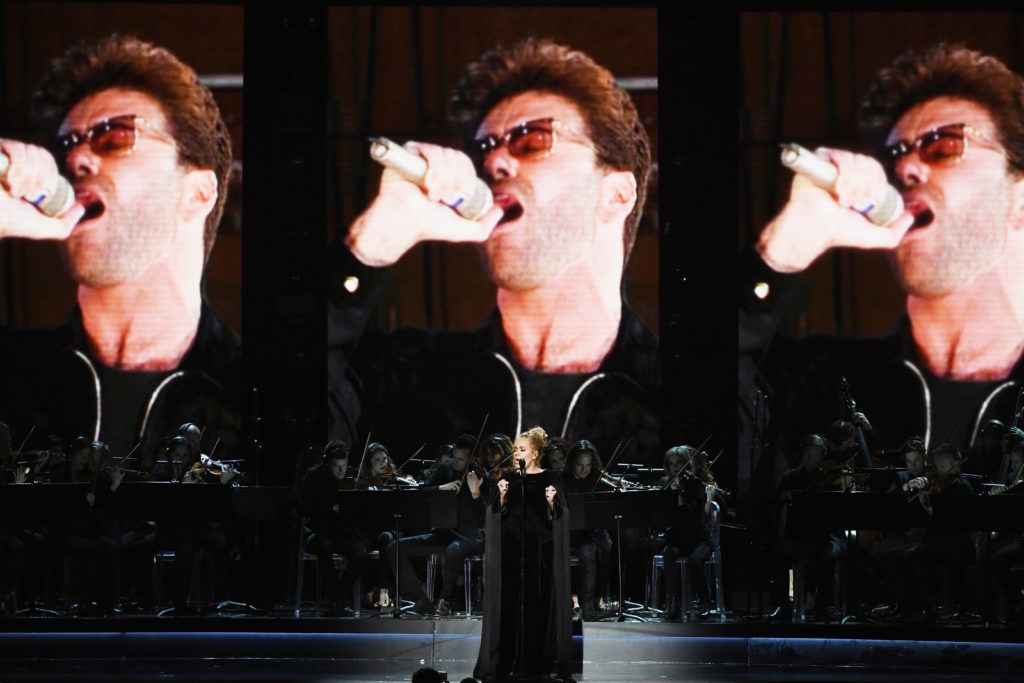 LOS ANGELES, CA - FEBRUARY 12:  An image of the late George Michael is projected on a video screen while recording artist Adele performs onstage during The 59th GRAMMY Awards at STAPLES Center on February 12, 2017 in Los Angeles, California.  (Photo by Kevin Winter/Getty Images for NARAS)