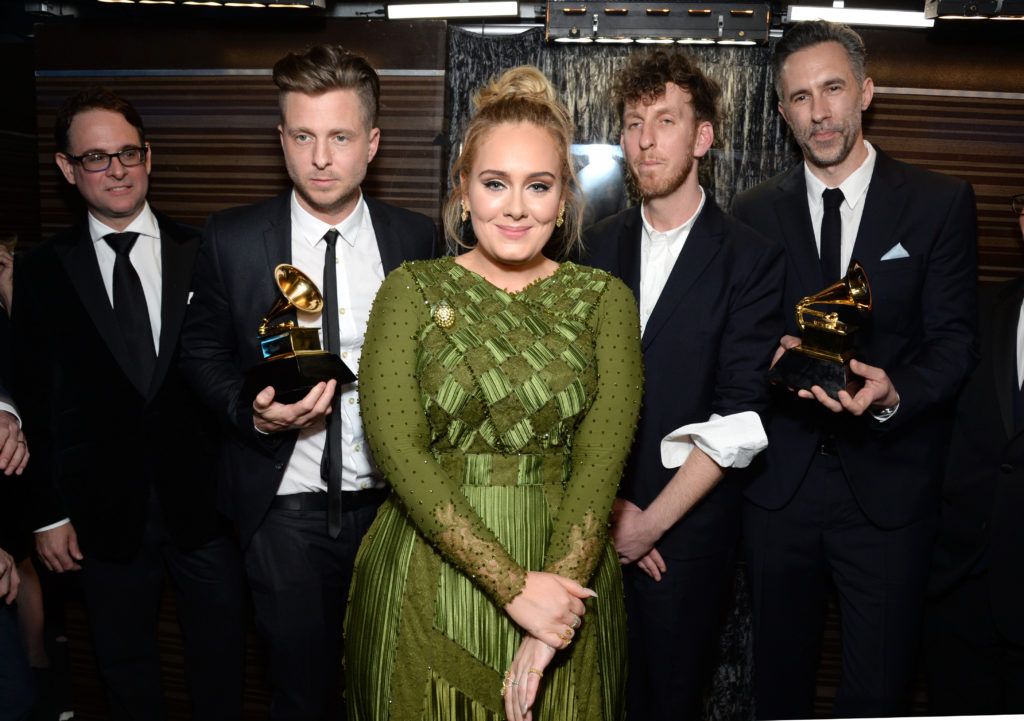 LOS ANGELES, CA - FEBRUARY 12:  Recording artist-producer Ryan Tedder (second from left), recording artist Adele (C), producer Ariel Rechtshaid (second from right), and producer Samuel Dixon (R), co-recipients of the Album Of The Year award for '25,' pose backstage during the The 59th GRAMMY Awards at STAPLES Center on February 12, 2017 in Los Angeles, California.  (Photo by Michael Kovac/Getty Images for NARAS)