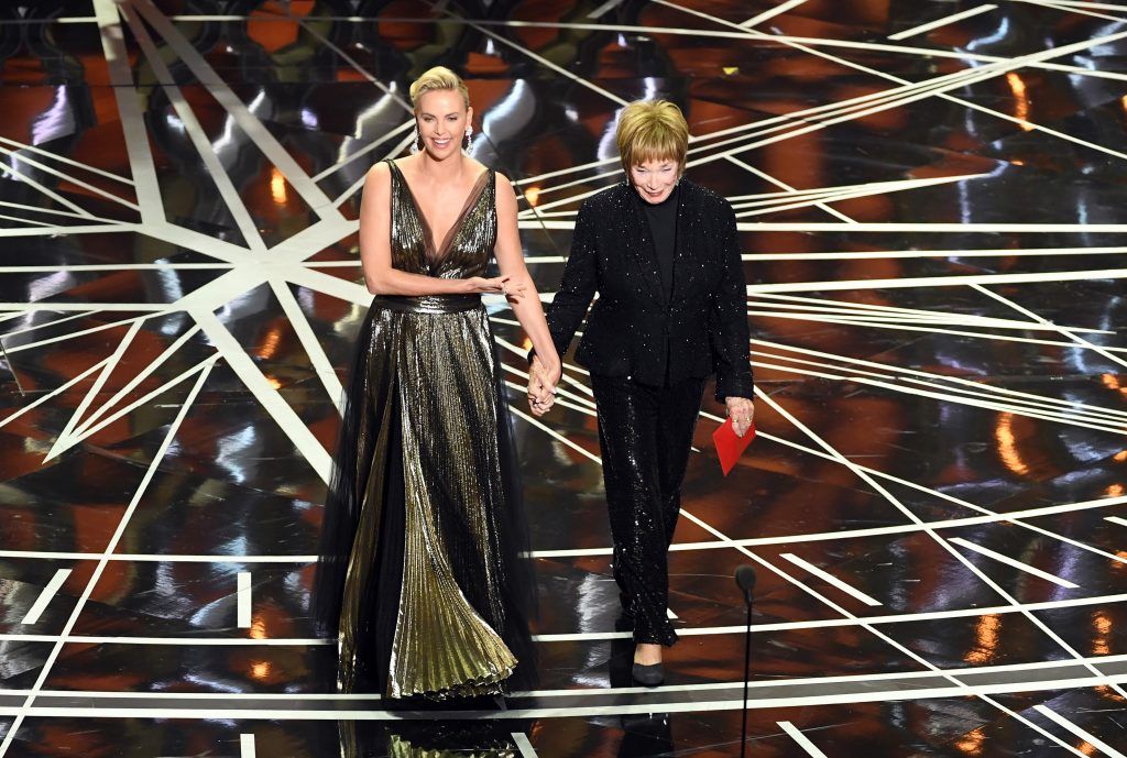 HOLLYWOOD, CA - FEBRUARY 26:  Actors Charlize Theron (L) and Shirley MacLaine walk onstage during the 89th Annual Academy Awards at Hollywood & Highland Center on February 26, 2017 in Hollywood, California.  (Photo by Kevin Winter/Getty Images)