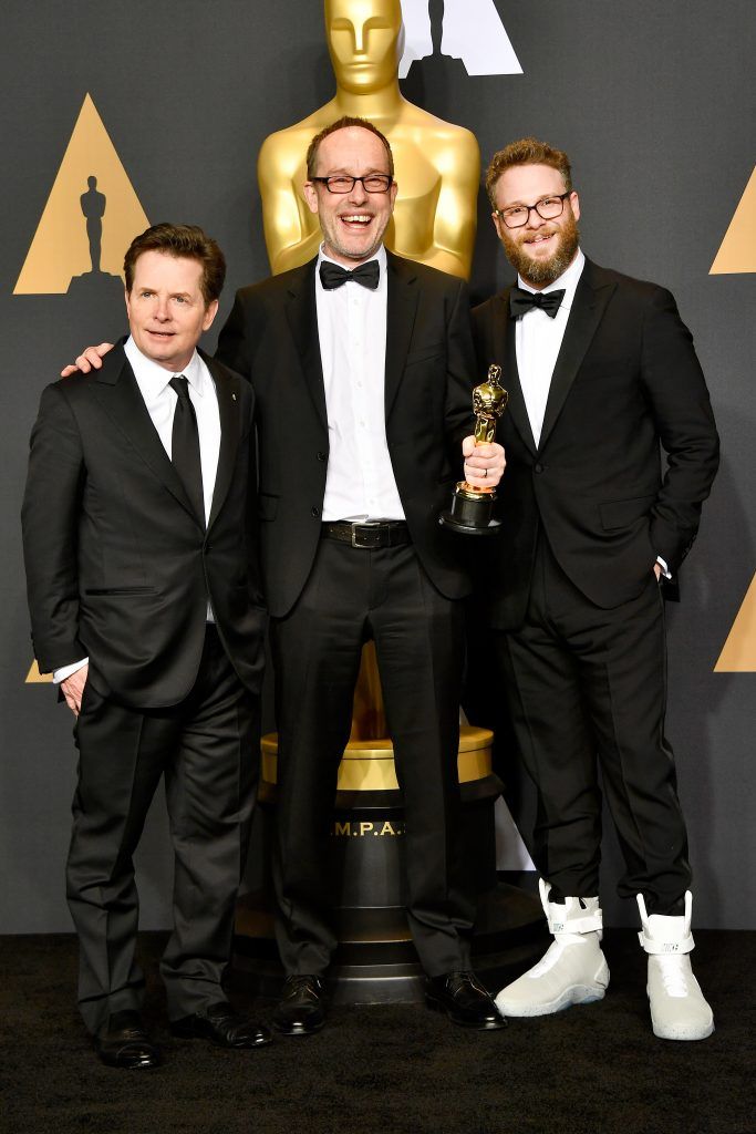 HOLLYWOOD, CA - FEBRUARY 26:  (L-R) Actor Michael J. Fox, editor John Gilbert, winner of Best Film Editing for 'Hacksaw Ridge' and actor Seth Rogen pose in the press room during the 89th Annual Academy Awards at Hollywood & Highland Center on February 26, 2017 in Hollywood, California.  (Photo by Frazer Harrison/Getty Images)