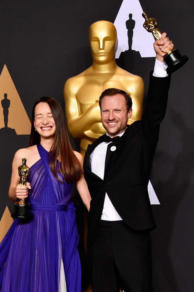HOLLYWOOD, CA - FEBRUARY 26:  Producer Joanna Natasegara (L) and director Orlando von Einsiedel, winners of Best Documentary Short Subject for 'The White Helmets' pose in the press room during the 89th Annual Academy Awards at Hollywood & Highland Center on February 26, 2017 in Hollywood, California.  (Photo by Frazer Harrison/Getty Images)