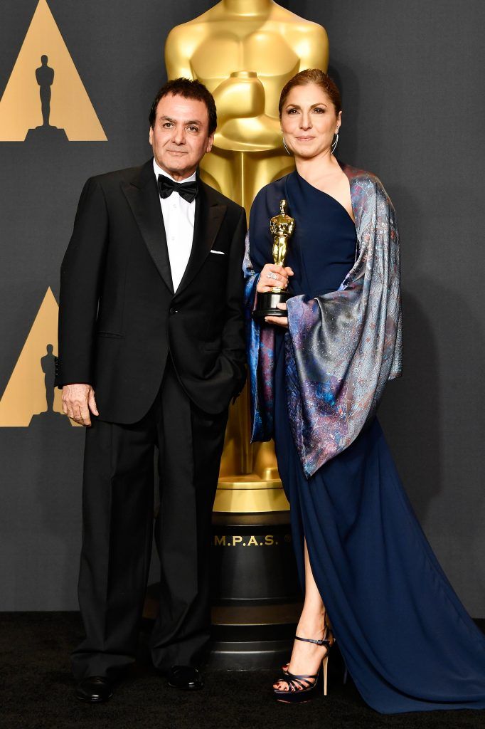 HOLLYWOOD, CA - FEBRUARY 26:  Former NASA scientist Firouz Naderi (L) and engineer/astronaut Anousheh Ansari pose with the Best Foreign Language Film award for 'The Salesman' on behalf of director Asghar Farhadi in the press room during the 89th Annual Academy Awards at Hollywood & Highland Center on February 26, 2017 in Hollywood, California.  (Photo by Frazer Harrison/Getty Images)