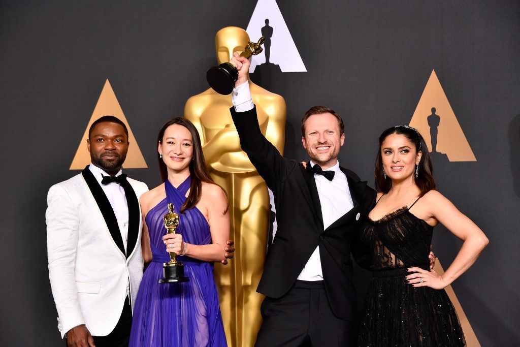 HOLLYWOOD, CA - FEBRUARY 26:  Director Orlando von Einsiedel and producer Joanna Natasegara winners of the award for winners of the best Documentary Short Subject for 'The White Helmets'pose with presenters David Oyelowo (R) and Salma Hayek in the press room during the 89th Annual Academy Awards at Hollywood & Highland Center on February 26, 2017 in Hollywood, California.  (Photo by Frazer Harrison/Getty Images)