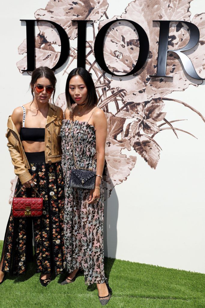 Brazilian blogger Camila Coelho and Aimee Song pose during the photocall before Christian Dior 2017 fall/winter Haute Couture collection show in Paris on July 3, 2017. (Photo by Patrick Kovarik/AFP/Getty Images)