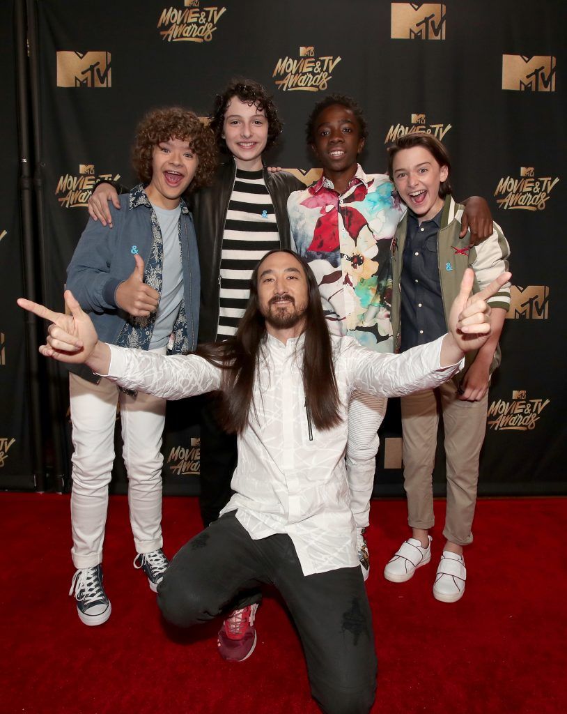 LOS ANGELES, CA - MAY 07:  (L-R) Actors Gaten Matarazzo, Finn Wolfhard, musician Steve Aoki, and actors Caleb McLaughlin and Noah Schnapp attend the 2017 MTV Movie And TV Awards at The Shrine Auditorium on May 7, 2017 in Los Angeles, California.  (Photo by Christopher Polk/Getty Images)