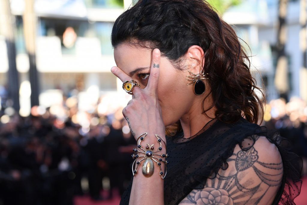 Italian actress Asia Argento poses as she arrives on May 17, 2017 for the screening of the film 'Ismael's Ghosts' during the opening ceremony of the 70th edition of the Cannes Film Festival in Cannes, southern France. (Photo ANNE-CHRISTINE POUJOULAT/AFP/Getty Images)