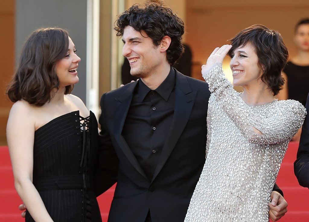 Marion Cotillard, French actor Louis Garrel and French actress Charlotte Gainsbourg pose as they arrive on May 17, 2017 for the screening of their film 'Ismael's Ghosts' (Les Fantomes d'Ismael) during the opening ceremony of the 70th edition of the Cannes Film Festival in Cannes, southern France.  (Photo VALERY HACHE/AFP/Getty Images)