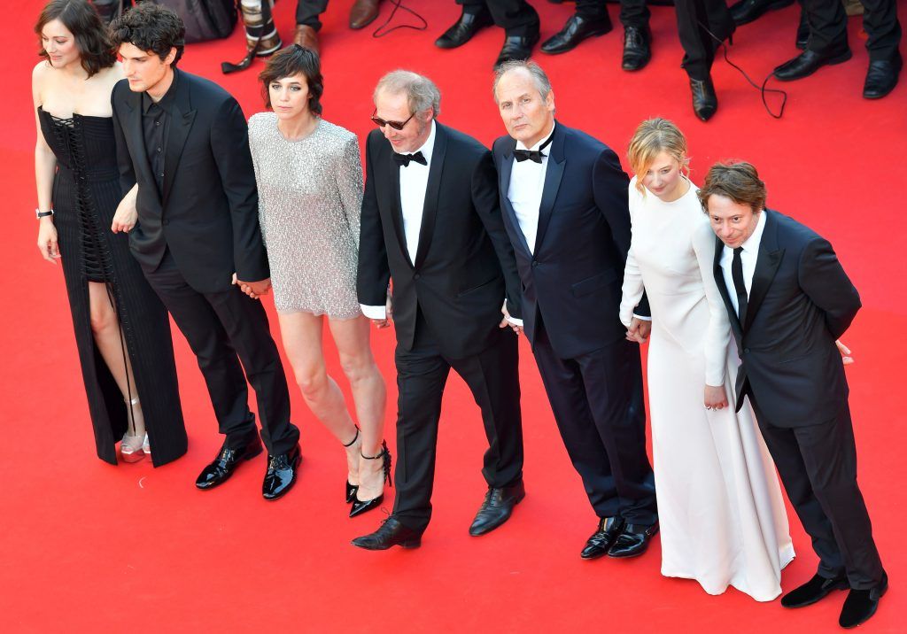 (FromL) French actress Marion Cotillard, French actor Louis Garrel, French actress Charlotte Gainsbourg, French director Arnaud Desplechin, French actor Hippolyte Girardot, Italian actress Alba Rohrwacher and French actor Mathieu Amalric pose as they arrive on May 17, 2017 for the screening of their film 'Ismael's Ghosts' (Les Fantomes d'Ismael) during the opening ceremony of the 70th edition of the Cannes Film Festival in Cannes, southern France. (Photo LOIC VENANCE/AFP/Getty Images)