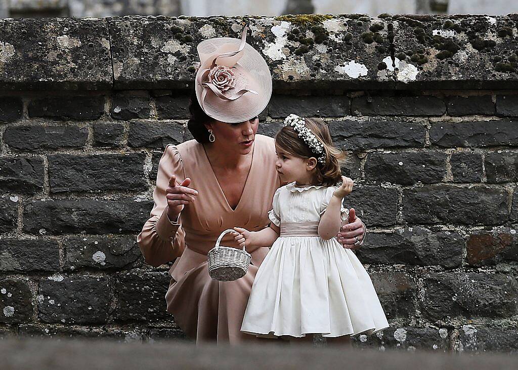 Britain's Catherine, Duchess of Cambridge (L) speaks to her daughter Britain's princess Charlotte, a bridesmaid, following the wedding of her sister Pippa Middleton to James Matthews at St Mark's Church in Englefield, west of London, on May 20, 2017. (Photo by KIRSTY WIGGLESWORTH/AFP/Getty Images)