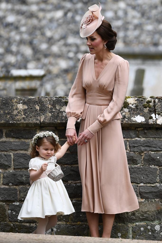 ENGLEFIELD GREEN, ENGLAND - MAY 20:  Catherine, Duchess of Cambridge stands with her daughter Princess Charlotte of Cambridge, a bridesmaid, following the wedding of her sister Pippa Middleton to James Matthews at St Mark's Church on May 20, 2017 in Englefield Green, England.  (Photo by Justin Tallis - WPA Pool/Getty Images)
