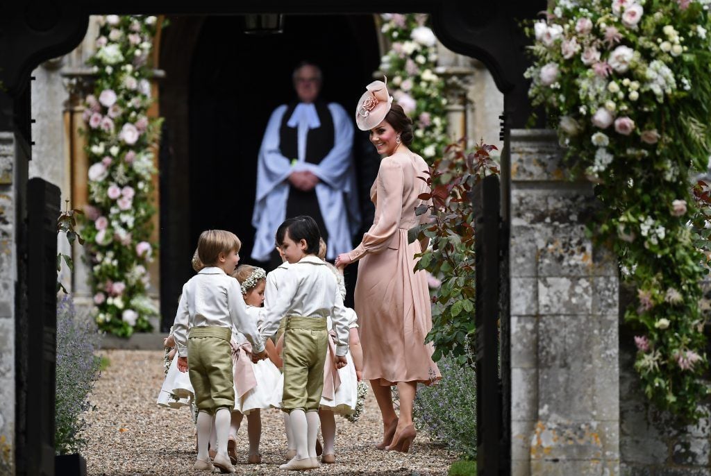 Britain's Catherine, Duchess of Cambridge (R) walks with the bridesmaids and pageboys as they arrive as they arrive for her sister Pippa Middleton's wedding to James Matthews at St Mark's Church on May 20, 2017 in Englefield Green, England.  (Photo by Justin Tallis - WPA Pool/Getty Images)