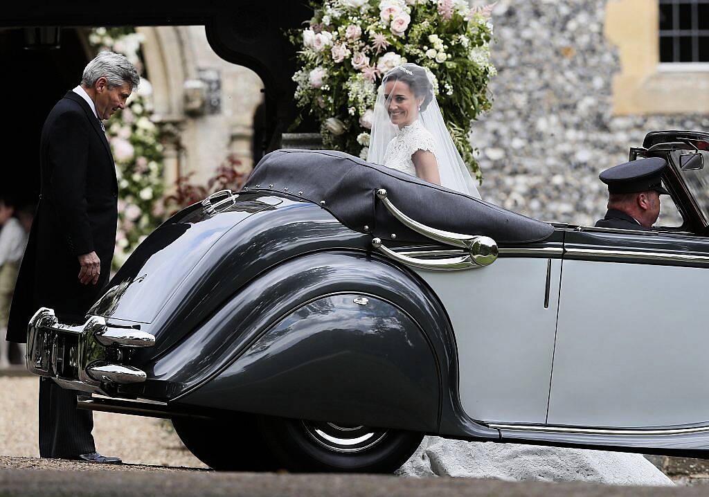 Pippa Middleton arrives with her father Michael Middleton (L) ahead of her wedding to James Matthews at St Mark's Church in Englefield, west of London, on May 20, 2017. (Photo by KIRSTY WIGGLESWORTH/AFP/Getty Images)