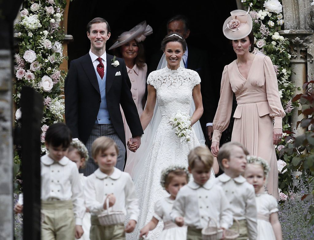Pippa Middleton and James Matthews smile as they are joined by Catherine, Duchess of Cambridge, right, after their wedding at St Mark's Church on May 20, 2017 in Englefield, England. (Photo by Kirsty Wigglesworth - Pool/Getty Images)