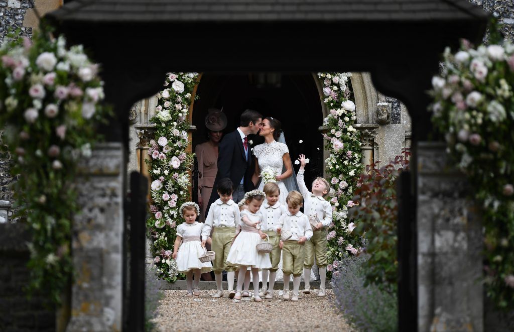 Pippa Middleton kisses her new husband James Matthews, following their wedding ceremony at St Mark's Church as the bridesmaids and pageboys walk ahead on May 20, 2017 in Englefield Green, England.  (Photo by Justin Tallis - WPA Pool/Getty Images)
