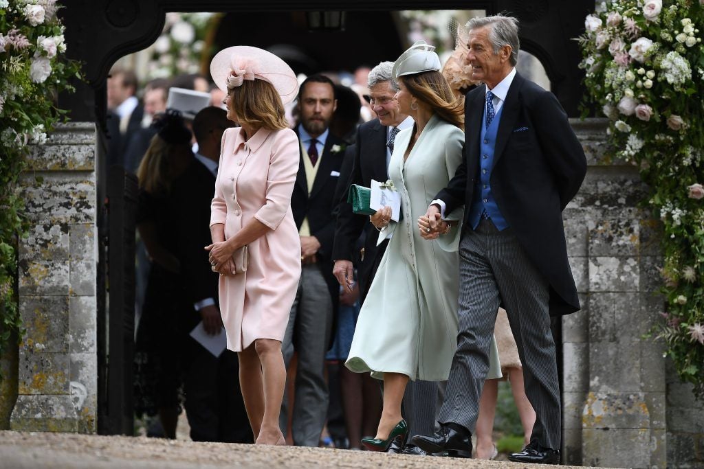 Carole Middleton (L), and her husband Michael Middleton (3R) leave St Mark's Church in Englefield, west of London, on May 20, 2017, after attending the wedding of their daughter Pippa Middleton to James Matthews. (Photo by JUSTIN TALLIS/AFP/Getty Images)