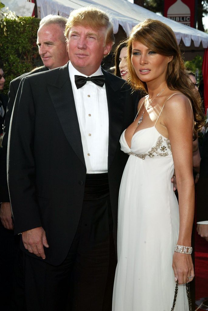 Donald Trump (left) and his fiance Melania Knauss attend the 56th Annual Primetime Emmy Awards on September 19, 2004 at the Shrine Auditorium, in Los Angeles, California. Ms. Knauss is wearing a J. Mendel gown and carrying a J. Mendel handbag. (Photo by Kevin Winter/Getty Images)