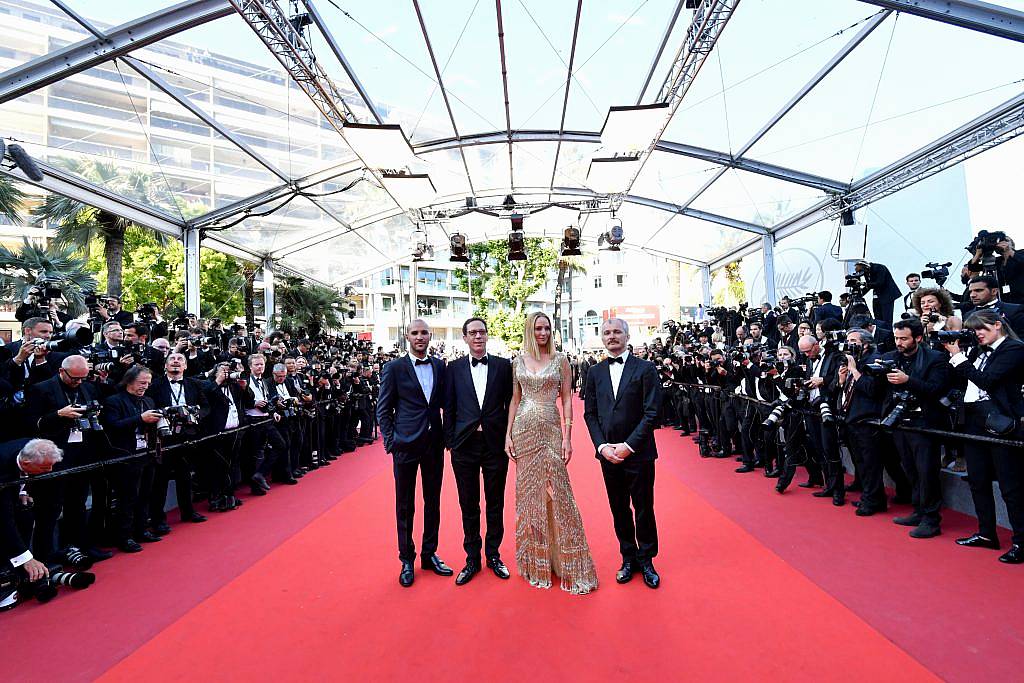 Joaquin Phoenix (L) and Lynne Ramsay (C) arrive on May 28, 2017 for the closing ceremony of the 70th edition of the Cannes Film Festival in Cannes, southern France. (Photo by LOIC VENANCE/AFP/Getty Images)