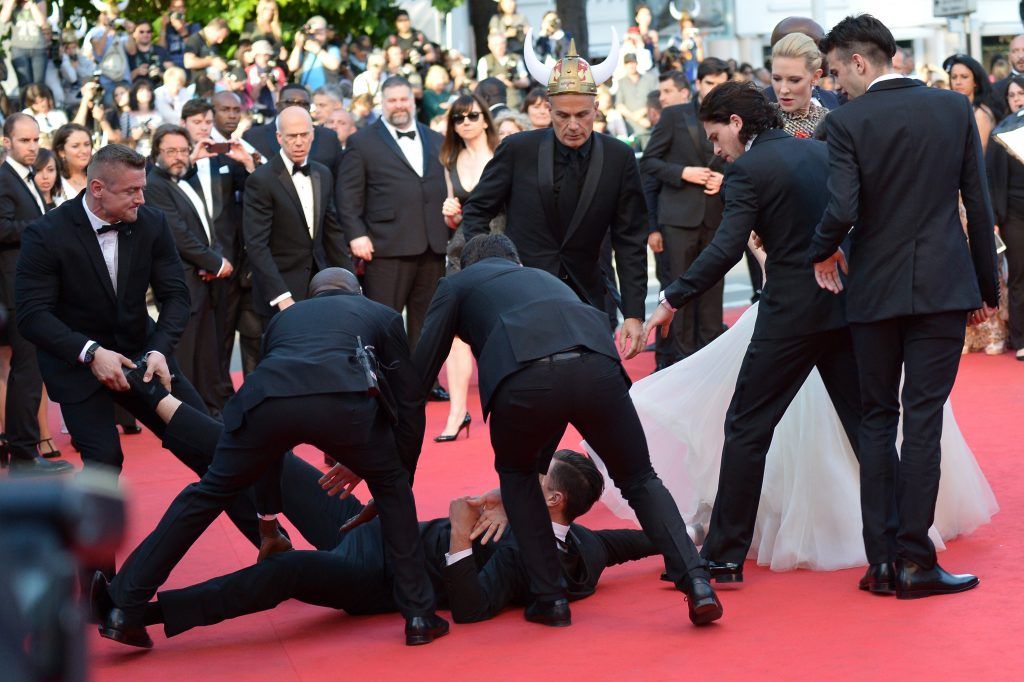 Ukrainian journalist and prankster Vitalii Sediuk tried to go under America Ferrera's dress at the Cannes Film Festival in 2014. He didn't get very far. (Photo by Alberto Pizzoli/AFP/Getty Images)