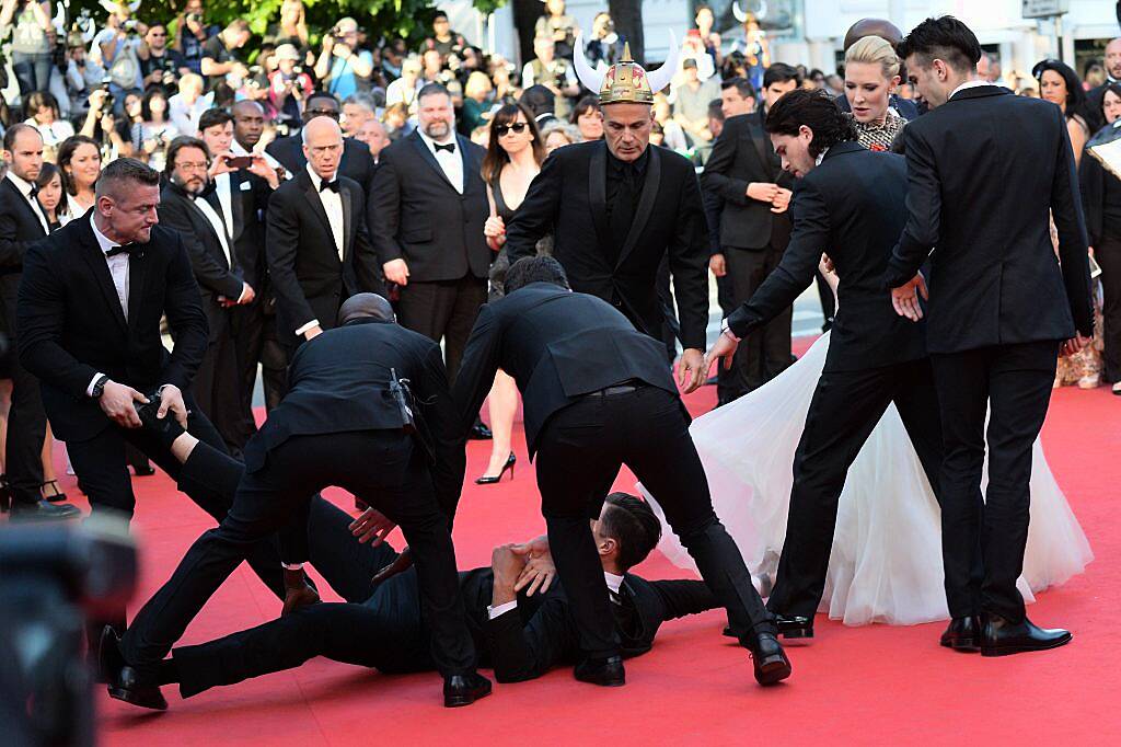 Ukrainian journalist and prankster Vitalii Sediuk tried to go under America Ferrera's dress at the Cannes Film Festival in 2014. He didn't get very far. (Photo by Alberto Pizzoli/AFP/Getty Images)