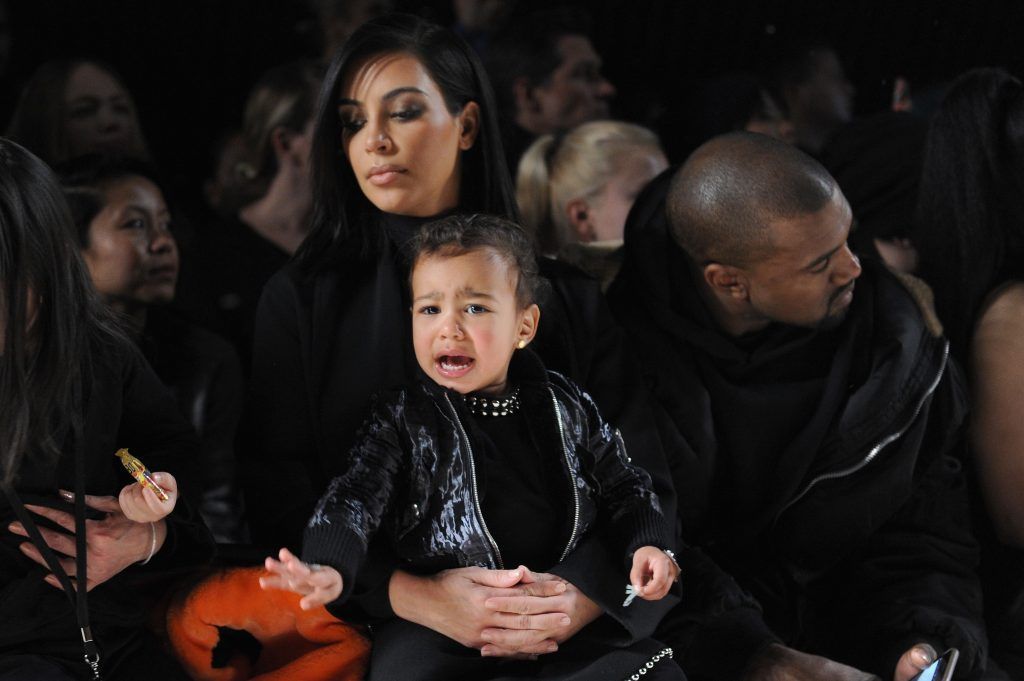 Kim Kardashian, North West and Kanye West attend the Alexander Wang Fashion Show during Mercedes-Benz Fashion Week Fall 2015 at Pier 94 on February 14, 2015 in New York City.  (Photo by Craig Barritt/Getty Images)