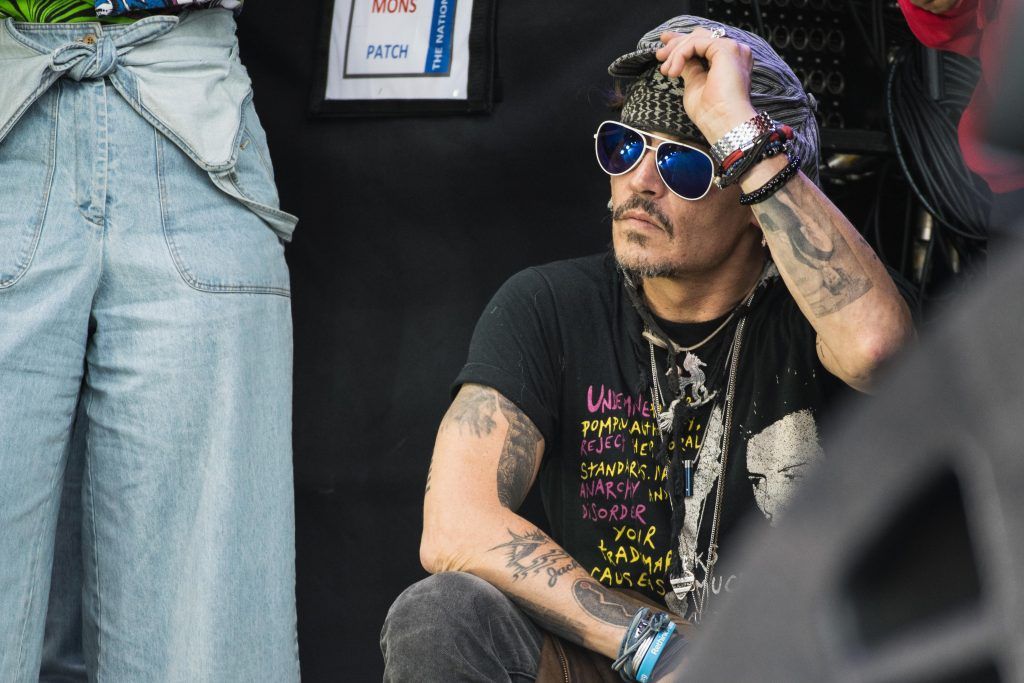 Johnny Depp sits at the side of the Pyramid Stage watching 'Run The Jewels' perform on day 3 of the Glastonbury Festival 2017 at Worthy Farm, Pilton on June 24, 2017 in Glastonbury, England.  (Photo by Ian Gavan/Getty Images)
