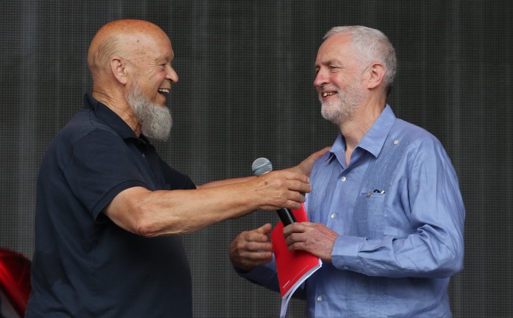 Labour Party leader Jeremy Corbyn (R) and festival founder Michael Eavis address the crowd from the main stage at the Glastonbury Festival site at Worthy Farm in Pilton on June 24, 2017 near Glastonbury, England. (Photo by Matt Cardy/Getty Images)