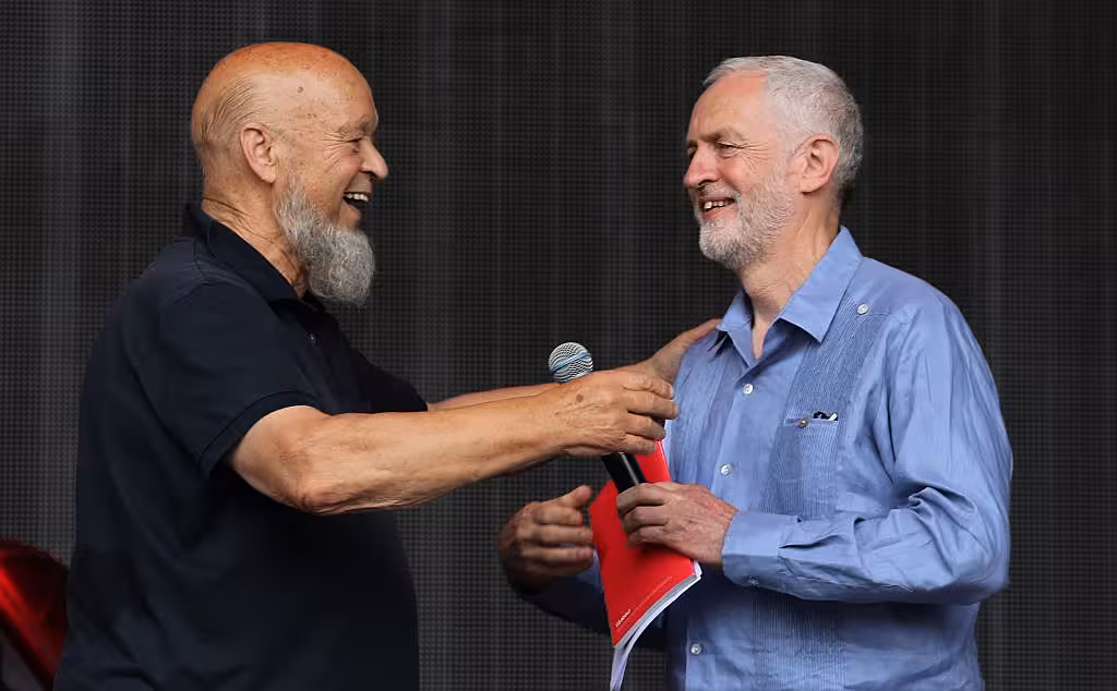 Labour Party leader Jeremy Corbyn (R) and festival founder Michael Eavis address the crowd from the main stage at the Glastonbury Festival site at Worthy Farm in Pilton on June 24, 2017 near Glastonbury, England. (Photo by Matt Cardy/Getty Images)