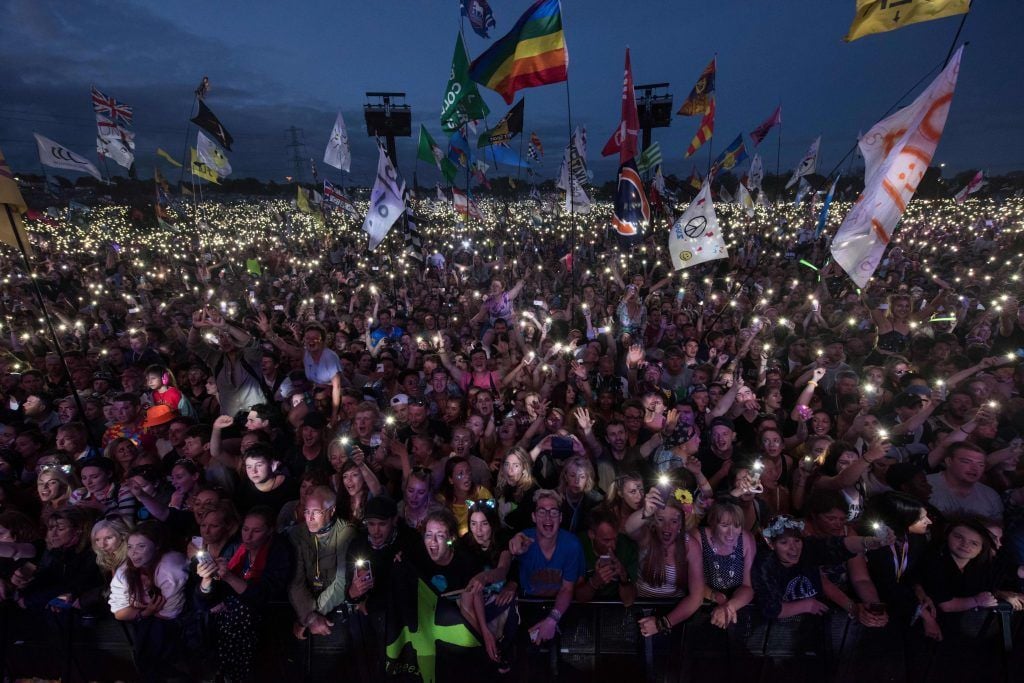 Fans listen as Ed Sheeran performs on the Pyramid Stage at the Glastonbury Festival of Music and Performing Arts on Worthy Farm near the village of Pilton in Somerset, south-west England, on June 25, (Photo by OLI SCARFF/AFP/Getty Images)