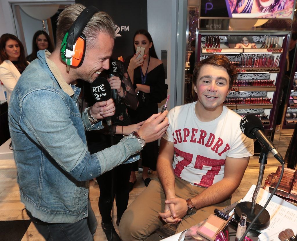 RTE 2FM'S 'The Nicky Byrne Show with Jenny Green' presenter Nicky Byrne gets to work on  Carl Mullen as they broadcast live from the new Urban Decay Boutique in Grafton Street Dublin. Picture by Brian McEvoy