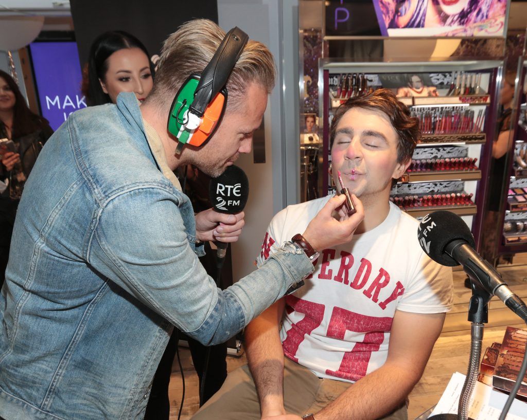 RTE 2FM'S 'The Nicky Byrne Show with Jenny Green' presenter Nicky Byrne gets to work on  Carl Mullen as they broadcast live from the new Urban Decay Boutique in Grafton Street Dublin. Picture by Brian McEvoy