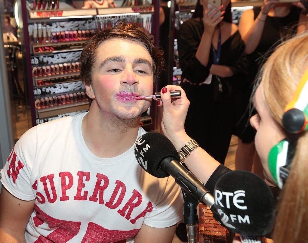 RTE 2FM'S 'The Nicky Byrne Show with Jenny Green' presenter Jenny Green gets to work on  Carl Mullen as they broadcast live from the new Urban Decay Boutique in Grafton Street Dublin. Picture by Brian McEvoy