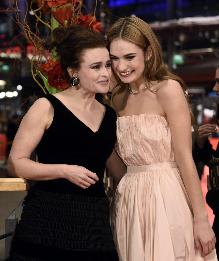 British actress Lily James (R) and British actress Helena Bonham Carter (L) pose on the red carpet prior to a screening of the film "Cinderella" presented in competition of the 65th Berlin International Film Festival Berlinale in Berlin, on February 13, 2015. (Photo by  ODD ANDERSEN/AFP/Getty Images)