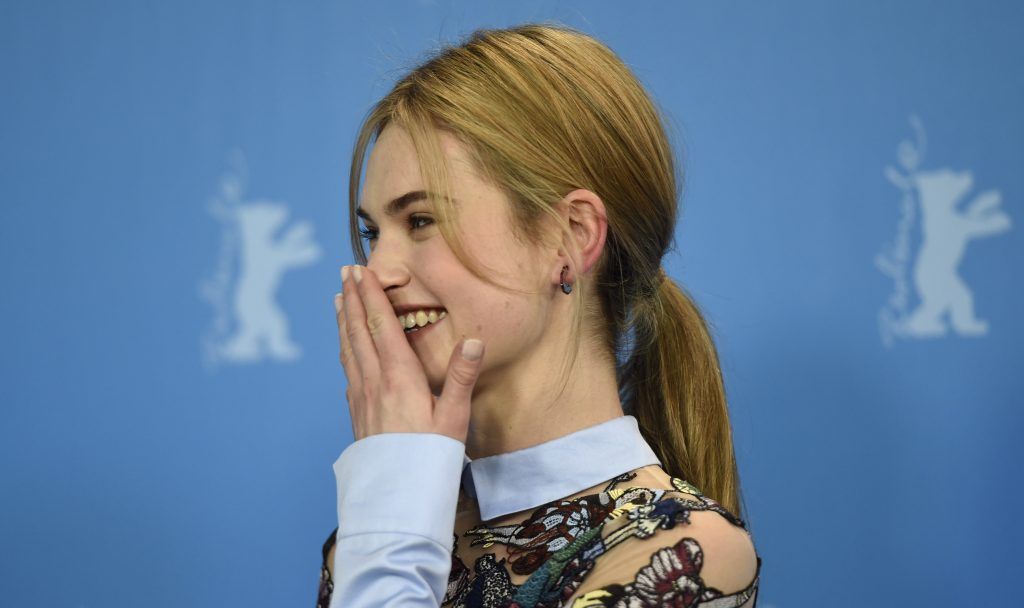 British actress Lily James poses for photographers during a photocall for the film "Cinderella" presented in competition of the 65th Berlin International Film Festival Berlinale in Berlin, on February 13, 2015.  (Photo by ODD ANDERSEN/AFP/Getty Images)