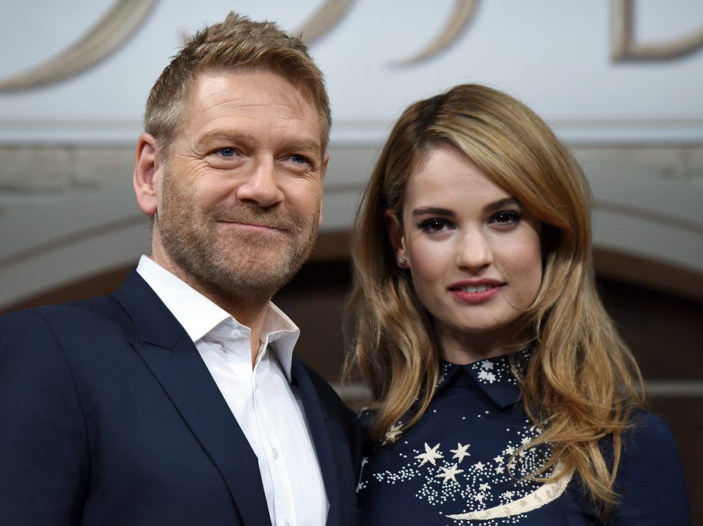British movie director Kenneth Branagh (L) and British actree Lily James pose for photographers during a press conference to promote their latest movie "Cinderella" in Tokyo on April 7, 2015.  The film will be shown all over Japan from April 25.  (Photo by TORU YAMANAKA/AFP/Getty Images)