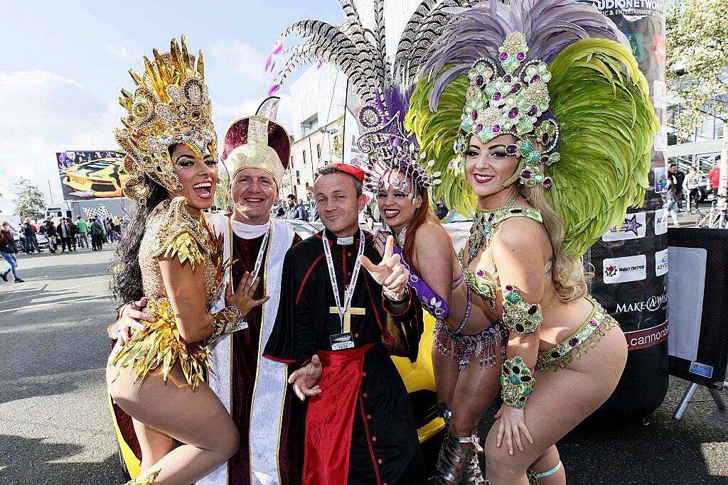 Paul McKenna and Aidan Scully from Dublin pictured with the Viva Brasil Samba girls at the start line of the supercar spectacle Cannonball 2017 in the Point Village, Dublin (8th September 2017). Picture by Andres Poveda